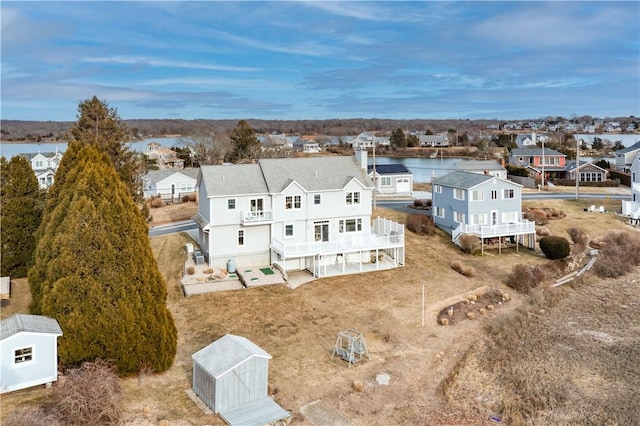 birds eye view of property with a residential view and a water view