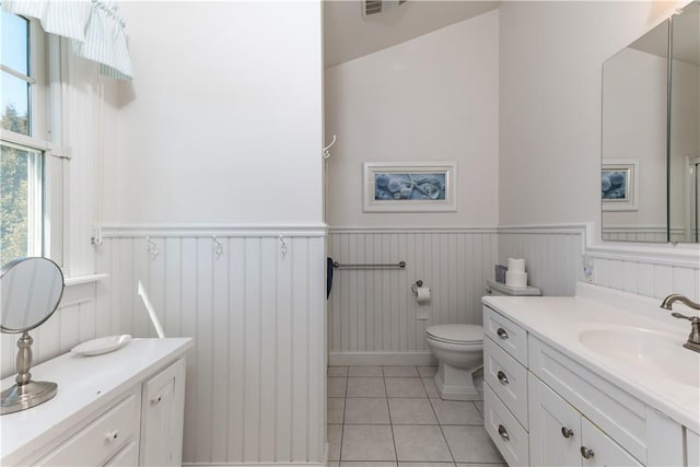 bathroom featuring visible vents, toilet, a wainscoted wall, tile patterned floors, and vanity