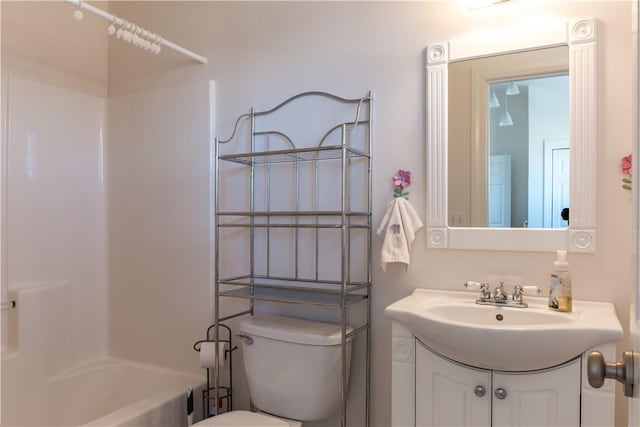 full bathroom with  shower combination, vanity, and toilet