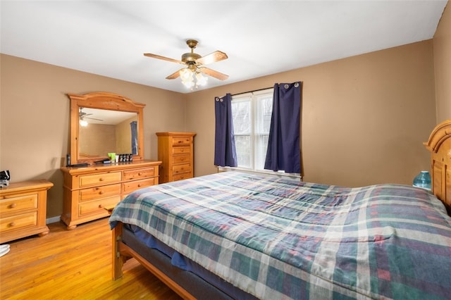 bedroom with light wood-style flooring and a ceiling fan