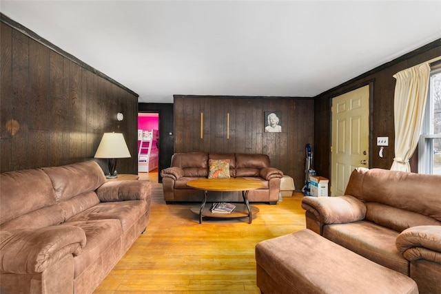 living area featuring wooden walls and light wood-style flooring