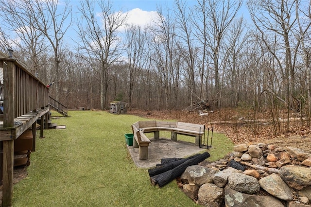 view of yard featuring a storage shed and an outbuilding