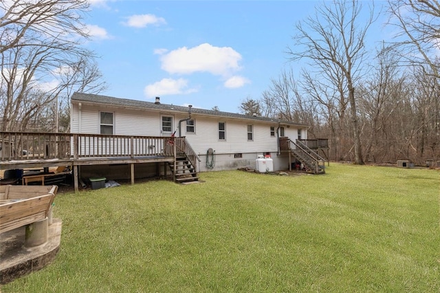 rear view of house featuring a deck and a lawn