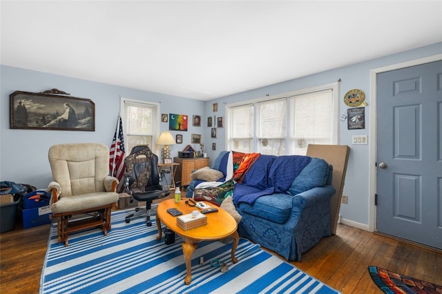 living area with baseboards and hardwood / wood-style floors