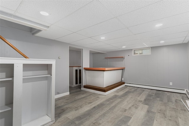 bar with a baseboard heating unit, wood finished floors, a paneled ceiling, and recessed lighting