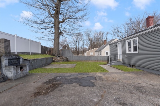 view of yard featuring fence and a patio