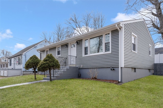 view of front of home with fence and a front lawn