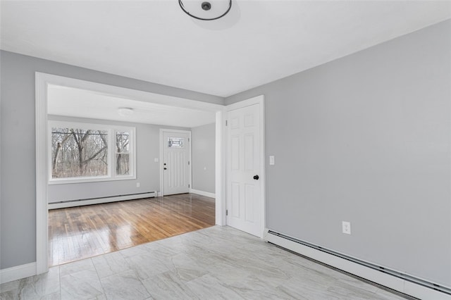 foyer featuring baseboards and baseboard heating