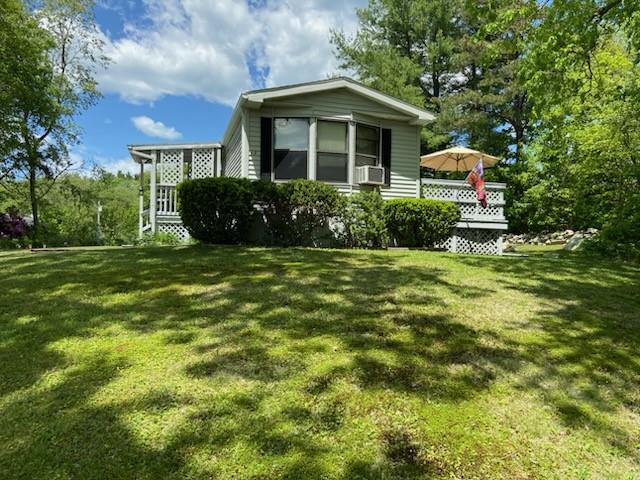 view of property exterior with a lawn