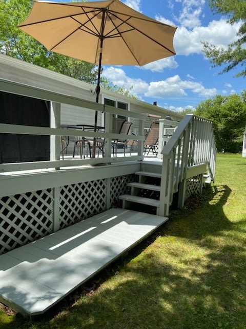 wooden deck featuring a yard