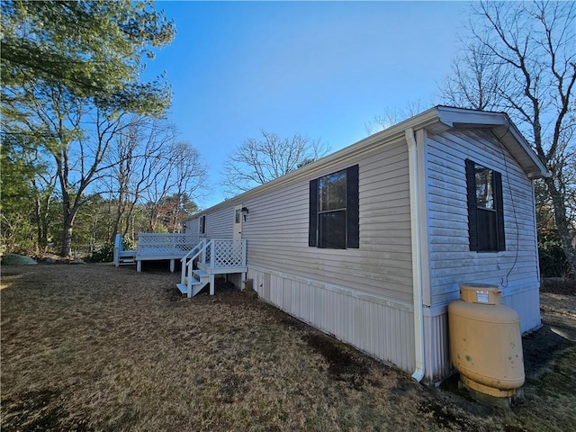 view of side of property featuring a wooden deck