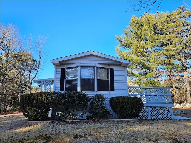 view of property exterior featuring a wooden deck