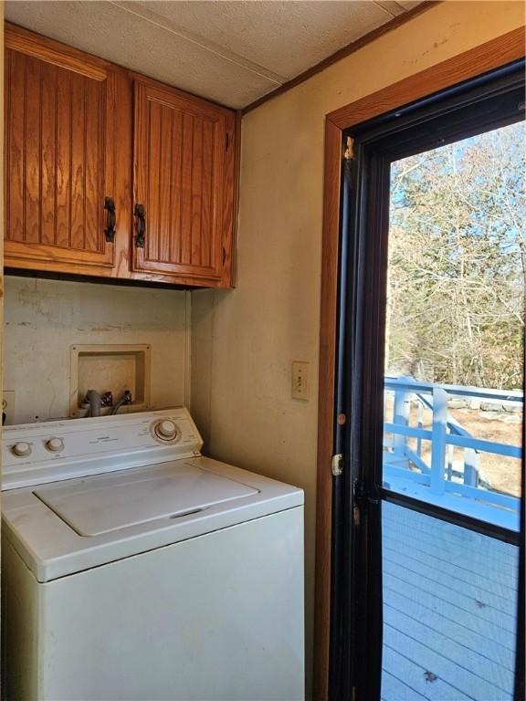 washroom featuring washer / clothes dryer and cabinet space