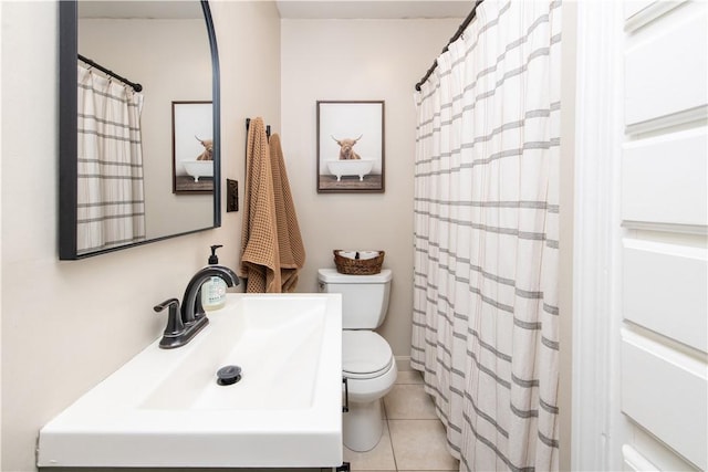 bathroom featuring toilet, tile patterned flooring, and a sink