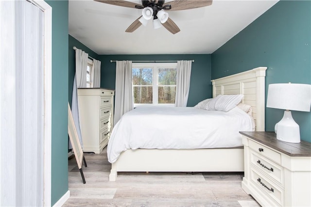 bedroom with light wood-type flooring and a ceiling fan