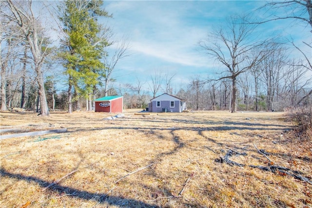 view of yard with an outbuilding and a shed