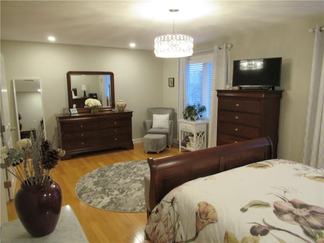 bedroom with wood finished floors and recessed lighting