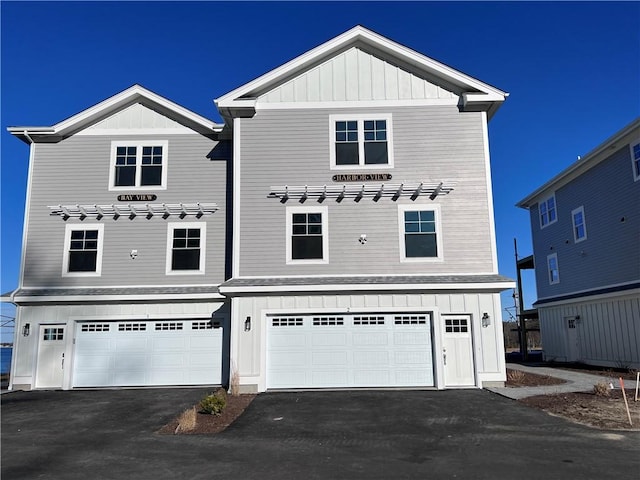 view of front of house with driveway, board and batten siding, and an attached garage