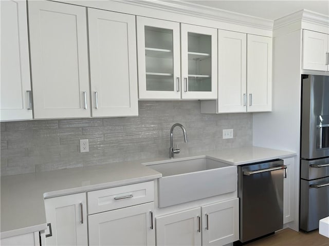 kitchen with a sink, light countertops, white cabinets, and stainless steel appliances