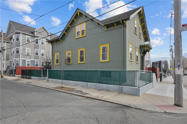 view of side of home featuring fence