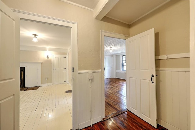 hall with wainscoting and hardwood / wood-style flooring