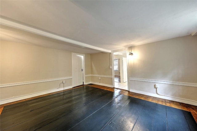 unfurnished room with wood-type flooring