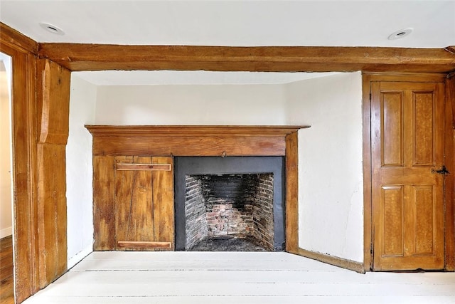 details with beam ceiling and a fireplace