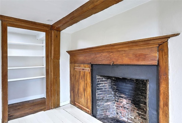 details with beamed ceiling, baseboards, and wood finished floors