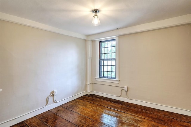 spare room with dark wood finished floors