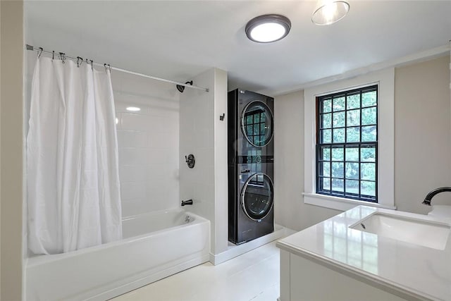 bathroom with vanity, stacked washer / drying machine, and shower / bath combo