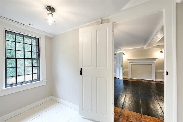 empty room with baseboards and wood-type flooring