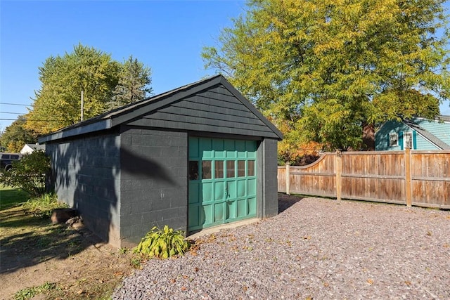 view of outbuilding featuring an outbuilding and fence