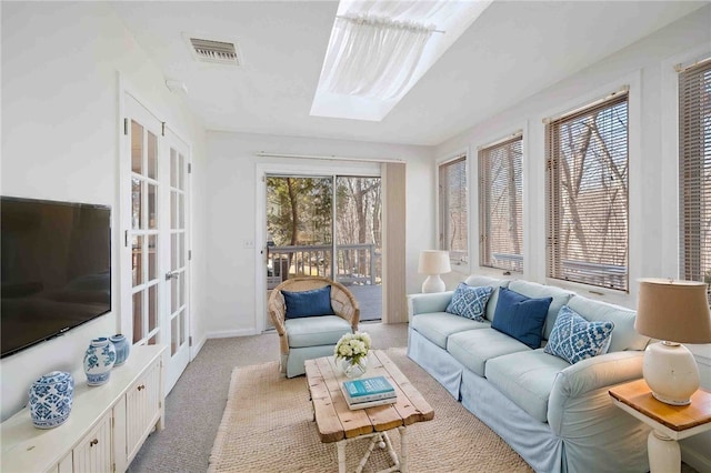 sunroom featuring a skylight and visible vents