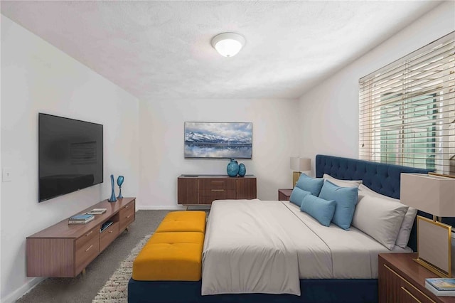 bedroom featuring baseboards, a textured ceiling, and light colored carpet