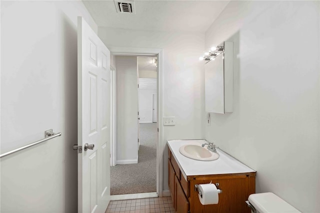 half bathroom with toilet, visible vents, and vanity