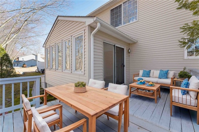 wooden deck featuring outdoor dining area and an outdoor living space