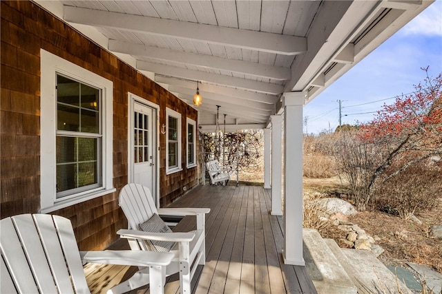 wooden terrace featuring covered porch