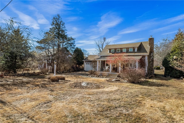 view of front of house with a garage, a porch, and a chimney