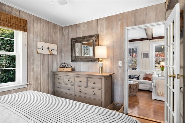 bedroom featuring french doors and wood finished floors