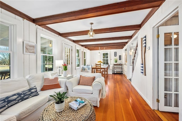 sunroom featuring beam ceiling