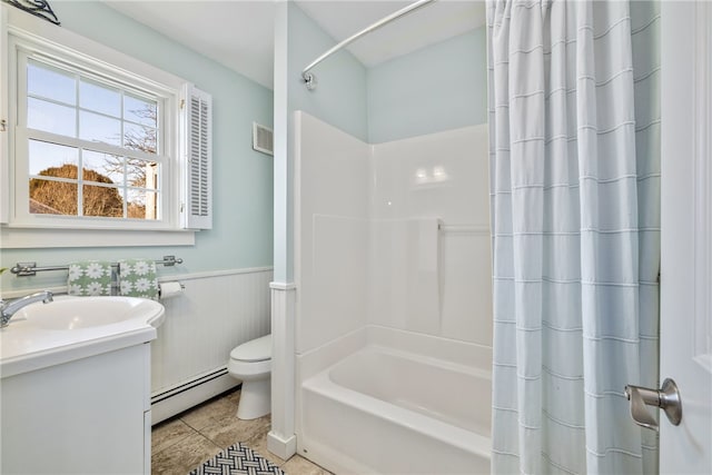 bathroom featuring toilet, baseboard heating, shower / bath combo, wainscoting, and tile patterned flooring