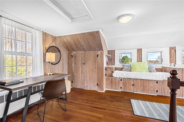 office area featuring a wealth of natural light, wood finished floors, and wood walls