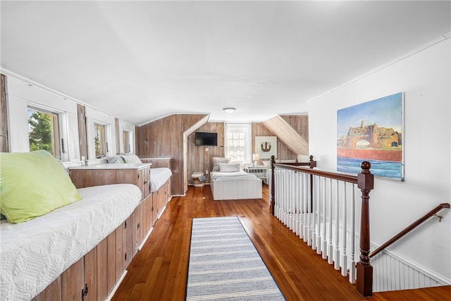 bedroom featuring vaulted ceiling, multiple windows, and hardwood / wood-style flooring