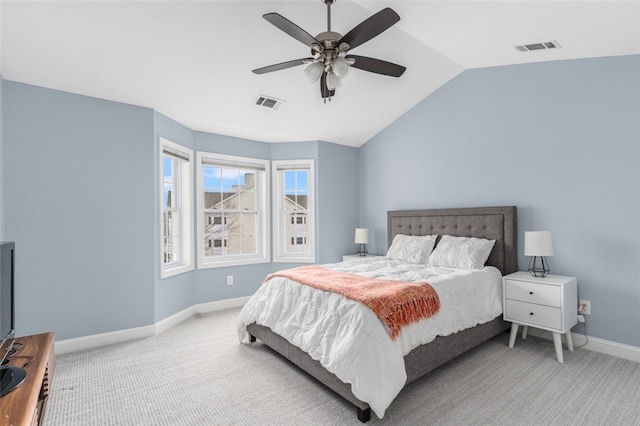 carpeted bedroom featuring lofted ceiling, baseboards, visible vents, and ceiling fan