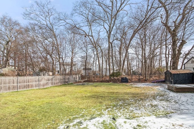 view of yard featuring an outbuilding, a shed, and a fenced backyard