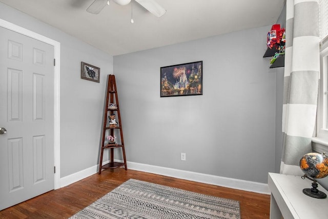 office space featuring ceiling fan, baseboards, and wood finished floors