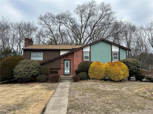 view of front of property with brick siding and a chimney