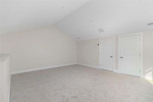 bonus room featuring lofted ceiling, carpet flooring, visible vents, and baseboards