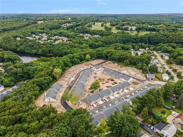 drone / aerial view featuring a forest view and a residential view