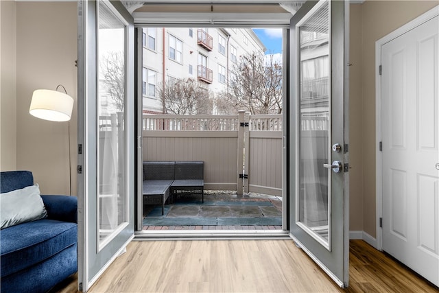 entryway featuring french doors, baseboards, and wood finished floors